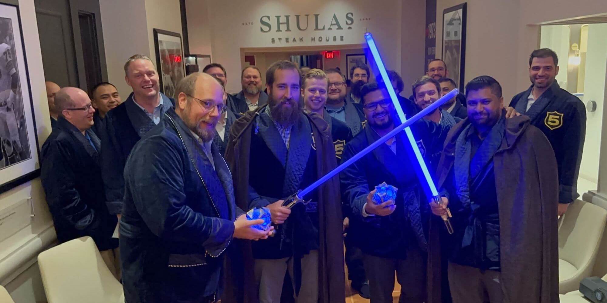 BSC team holding light sabers